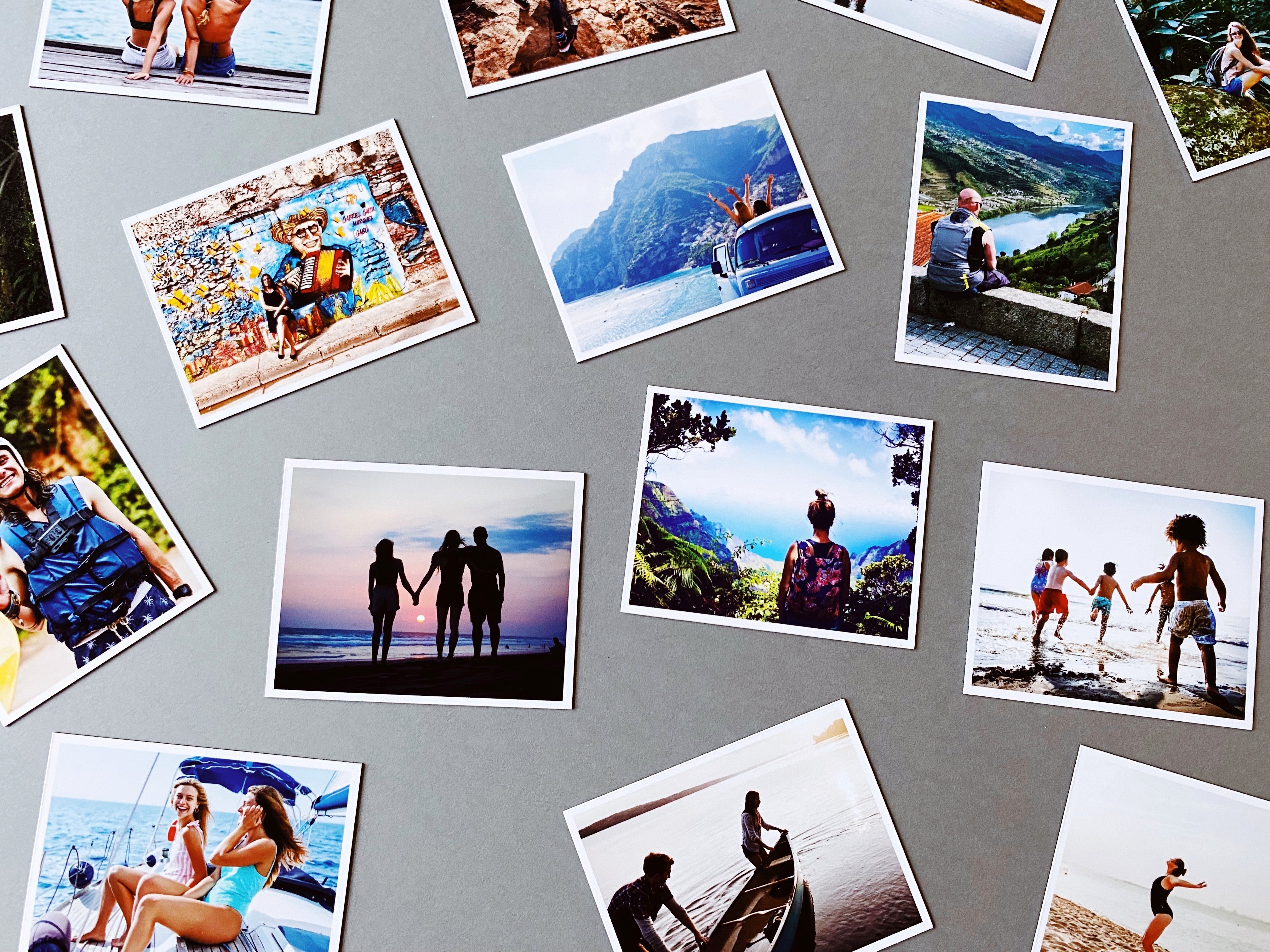 Rectangular custom photo magnets showing beach and travel memories on grey background, printed by Magnetic Love.