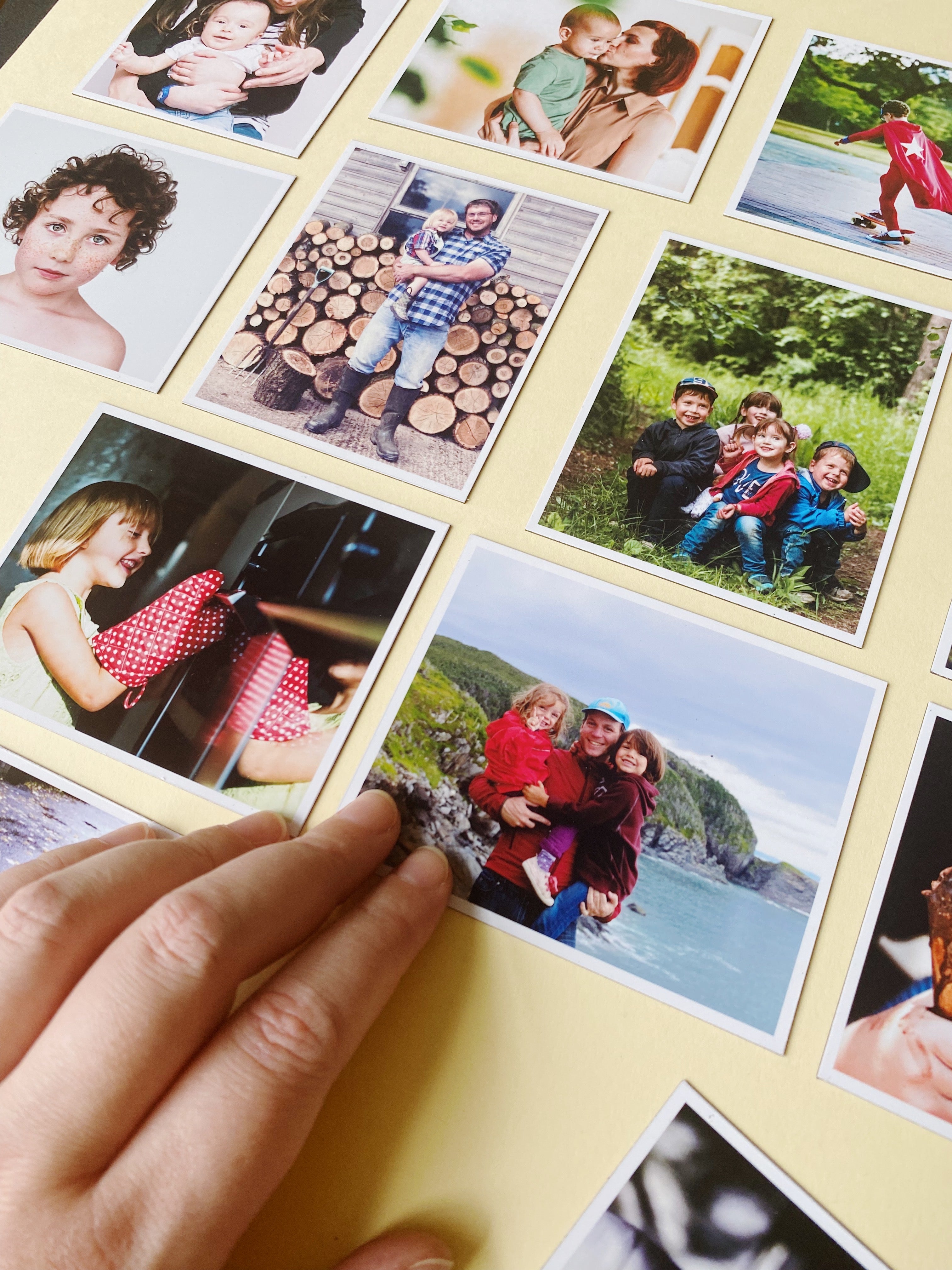 Hands holding custom photo magnets showing family travel memories printed by Magnetic Love.