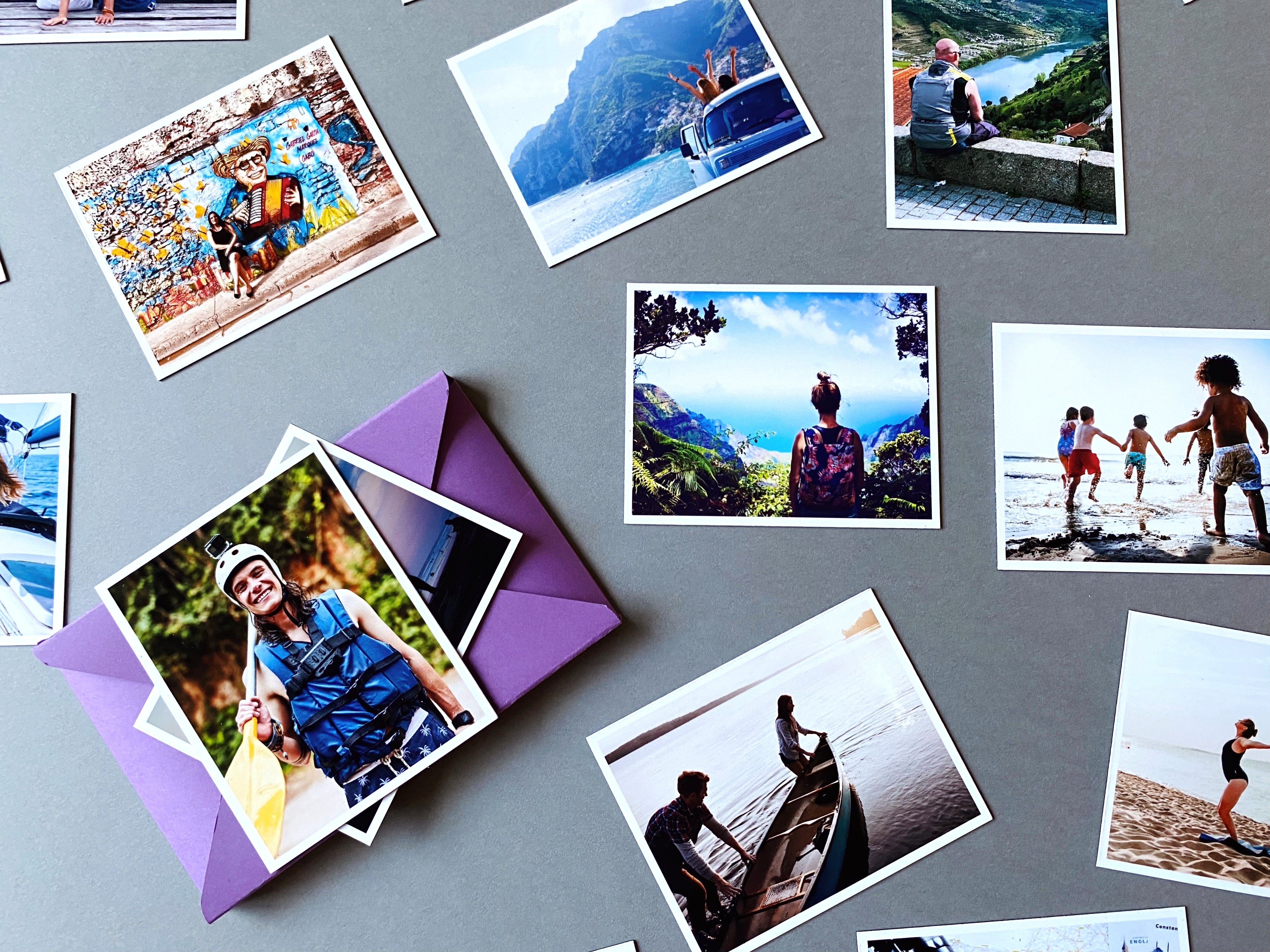 Collection of Magnetic Love photo magnets showing travel and friendship moments arranged on a grey background.