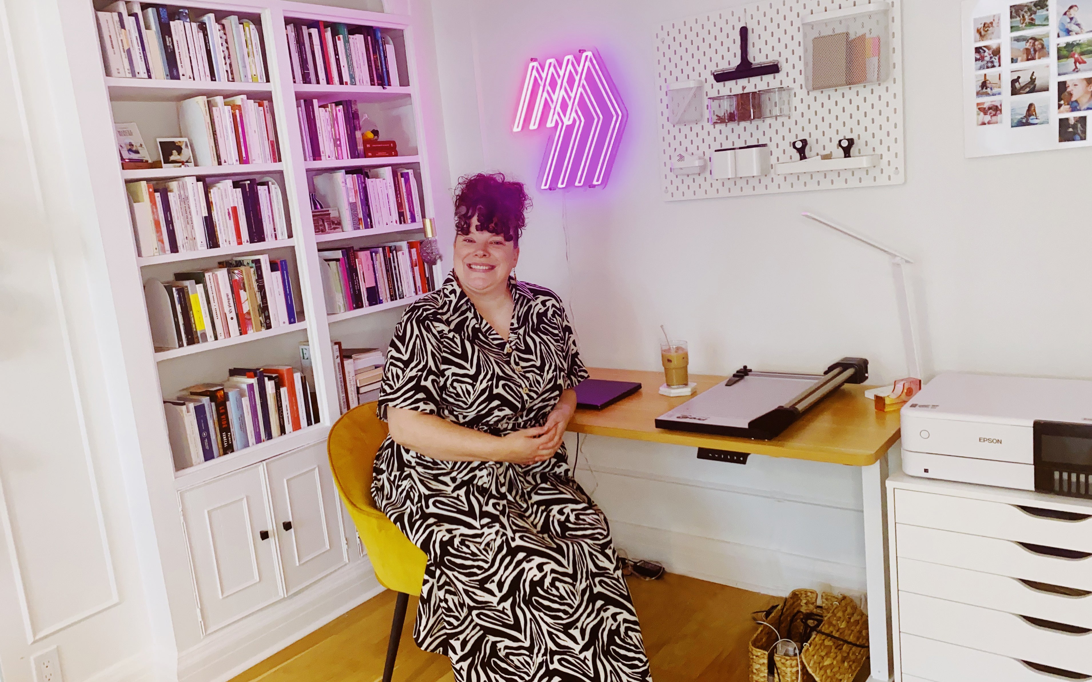 Magnetic Love founder working in her home studio, surrounded by books and printing equipment used to create handmade custom photo magnets.